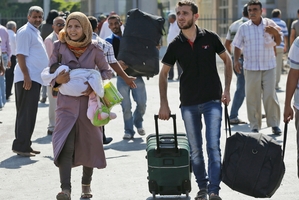 Syrian refugees flee into Turkey. The US says sarin gas was used in the Ghouta, Damascus, attack. Photo / AP