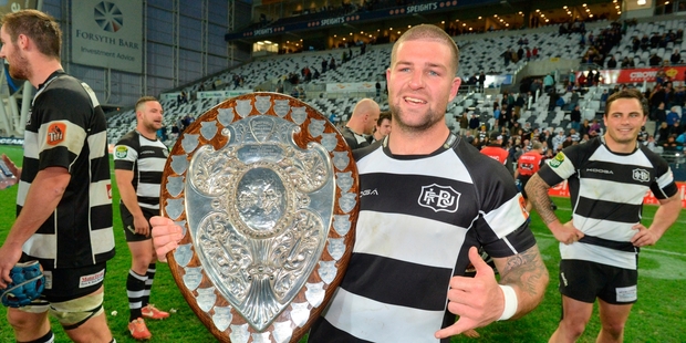 Chris Eaton holds the Ranfurly Shield in Dunedin after yesterday's win.
