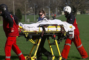 Victims of a crash at Atthurs Pass are taken to a waiting helicopter. Photo / 3 News