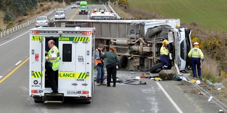 Wind is thought to have caused this truck to topple on the motorway just south of Waitati, near Dunedin. Photo / Otago Daily Times