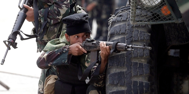 Government troops are trying to close in on the MNLF guerrillas without causing civilian casualties in the populated area. Picture / AP