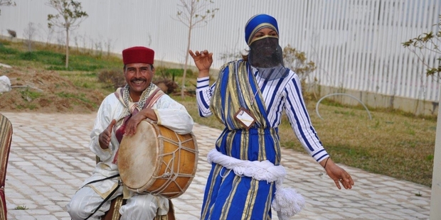 Street performers welcome cruise ship passengers from the MSC Preziosa into Tunis.