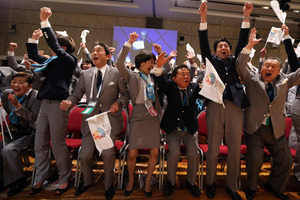 Shinzo Abe, second right, and other members of the Japanese delegation are delighted with the decision. Photo / AP