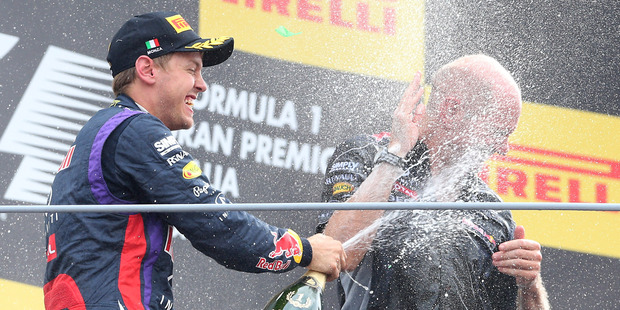 Red Bull driver Sebastian Vettel, left, of Germany, celebrates on the podium with Red Bull technical director Adrian Newey, after winning the Italian Grand Prix. Photo / AP