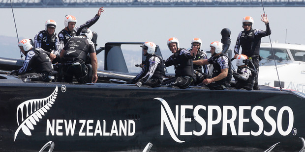 The crew on Emirates Team New Zealand wave to cheering spectators after one of the wins, but will they get a chance to race tomorrow? Photo / AP