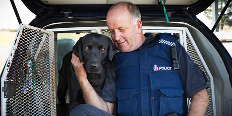 Senior Constable Bruce Lamb with his new dog, Mylo. Photo / Martin Hunter