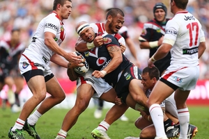 Dragons players wrap up Sam Rapira as the Warriors loss ended their faint playoff hopes. Photo / Getty Images
