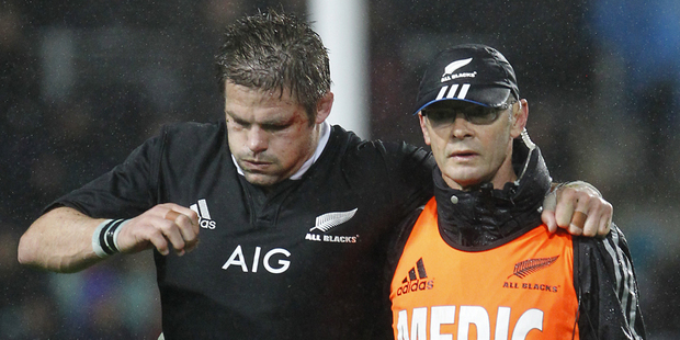 Richie McCaw is helped off the field after suffering a knee injury against Argentina. Photo / Getty Images