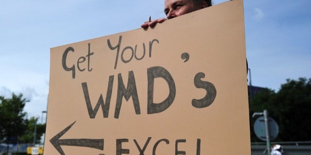 A protester holds a placard during a demonstration against the Defence and Security Equipment International (DSEI) arms fair at the ExCeL centre in east London. Photo / AFP
