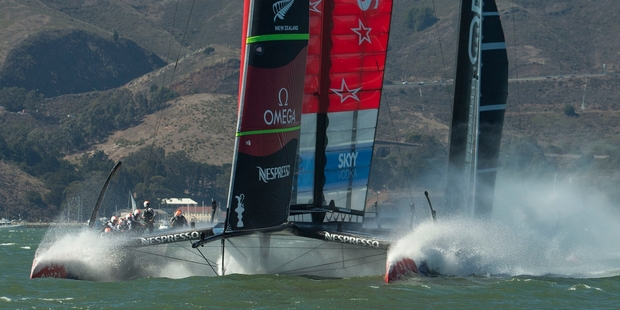 Some schools have been watching the races live. Left, supporters celebrate Team NZ's tense victory yesterday. Photo / Gilles Martin-Raget