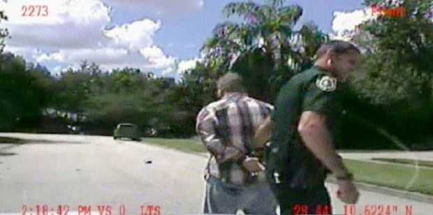 Dash-cam video image released by Police, George Zimmerman is detained by officers. Photo / AP