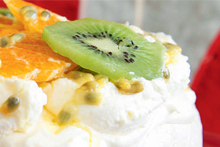 Pavlova with fruit and cream. Photo / Food Hub
