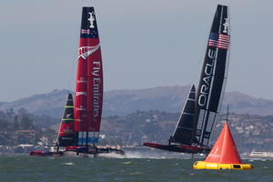 Emirates Team New Zealand lead Oracle towards the first mark before going on to win the first race yesterday morning. Photo / Brett Phibbs