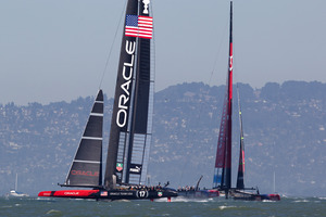 Oracle Team USA lead Emirates Team New Zealand in race 12. Photo / Brett Phibbs