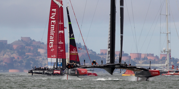 Oracle team USA heads to the finish line a head of Emirates Team New Zealand to win Race 13 of the America's Cup, on San Francisco Bay, San Francisco, California. Photo / Brett Phibbs.