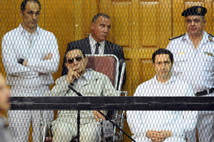 Former Egyptian President Hosni Mubarak, seated, and his two sons, Gamal Mubarak, left, and Alaa Mubarak, right. Photo / AP