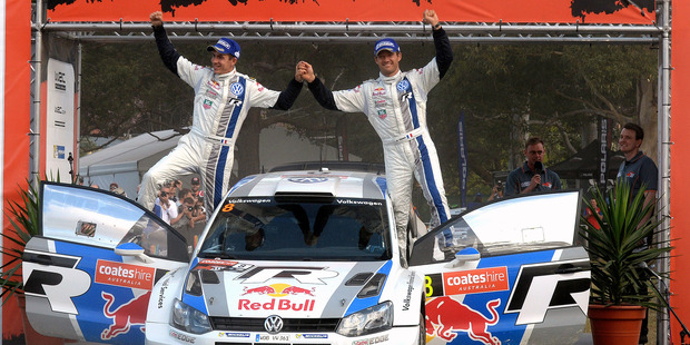 Sebastien Ogier, right, of France and his co-driver Julien Ingrassi celebrate winning the Rally Australia at Coffs Harbour. Photo / AP