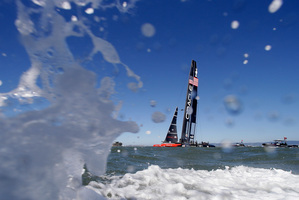 Oracle Team USA makes its way along the waterfront after winning the ninth race. Photo / AP