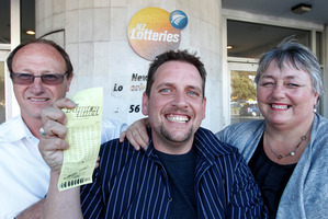 Trevor Cooper with his parents Kevin and Shirley and his winning Powerball ticket. Photo / Mark Mitchell