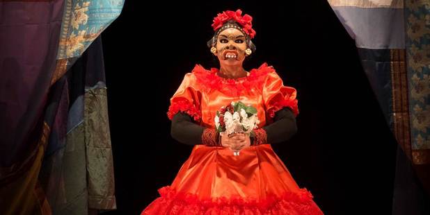 Nisha Madhan in Kiss the Fish , a production that pays homage to Balinese comic mask traditions with a bizarre menagerie of exotic characters.