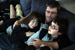 Richard Todd at home with daughters Brooke, 7, and Caitlin, 6. Photo / Doug Sherring