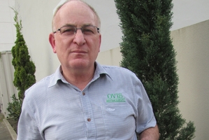 Dan Lynch, of Palmerston North company Ovis Management, with a sign to be placed at farm gates warning of the risks dogs pose if they haven't been treated for sheep measles.