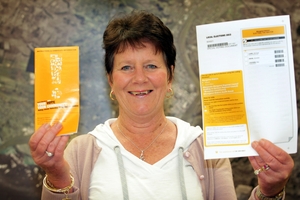 Noeline Moosman, Wanganui electoral officer, with a voting paper (right) and a voter's guide being mailed out from today. PHOTO / STUART MUNRO 190913WCSMVOTING PAPERS1