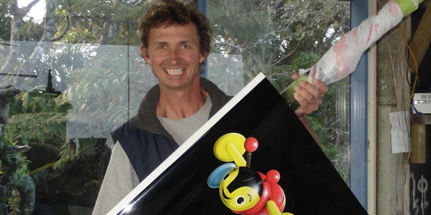 Whangarei-based airbrush artist Brad Walters shows off his handy work on a rudder used on Team New Zealand's hi-tech catamaran. Photo / Supplied