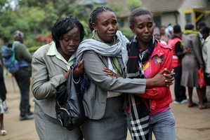 Relatives of Westgate Mall victim Johnny Mutinda Musango, 48, weep after identifying his body. Photo / AP