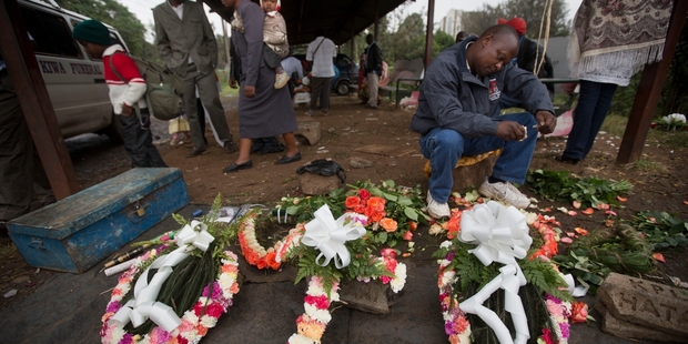 A street seller prepares wreaths for the dead. Photo / AP
Pictures / AP