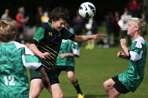 Kyle Grinlinton of Otumoetai Intermediate heads the ball clear. Photo / Joel Ford