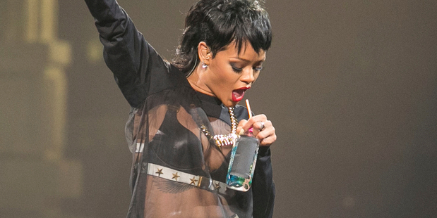 Rihanna takes a drink during a performance in Perth. Fans took to Twitter to say the pop star was drunk during the performance. Photo / AP