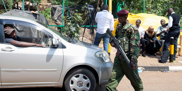 A Kenyan Para military soldier stops a vehicle to check, after security personnel opened part of the road leading to the Westgate Mall, in Nairobi. Photo / AP