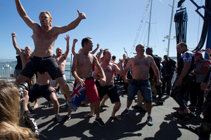 Emirates Team New Zealand supporters deliver a haka, after the dock out, at America's Cup Park before Race 17 of the America's Cup. Photo / Brett Phibbs