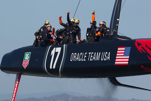 Oracle Team USA crosses the finish line ahead of Emirates Team New Zealand, but did anybody in the US notice? Photo / Brett Phibbs