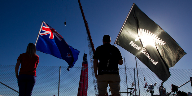 It's a lonely vigil for Kiwi fans (above) as Emirates Team New Zealand lift their boat into the water. Photo / Brett Phibbs