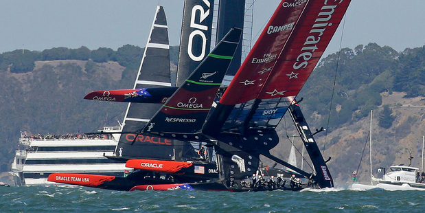 Emirates Team New Zealand, right, nearly capsizes during the eighth race of the America's Cup. Photo / AP