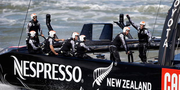 Emirates Team New Zealand sails near the waterfront after coming in second to Oracle Team USA during the final race. Photo / AP