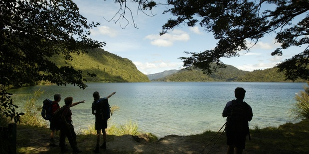 Hikers at a rest stop on a guided hike around Lake Waikaremoana. Photo / Amos Chapple