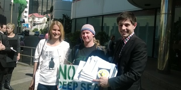 Surfing champ, Mischa Davis, Fi Gibson of Oil Free Wellington and Green Party energy spokesman Gareth Hughes outside Mbie this afternoon with their oil exploration bid.