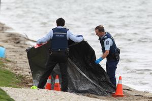 Police at Pilot Bay where a body has been found.