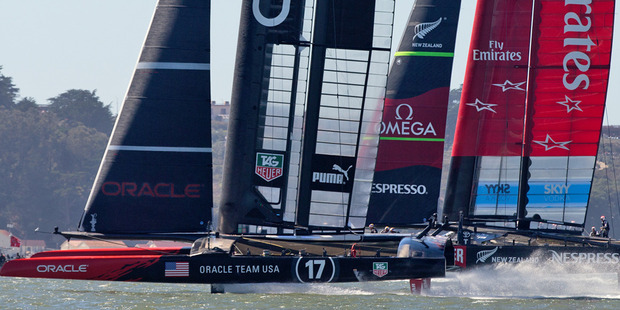Oracle Team USA beats Emirates Team New Zealand to the first mark in Race 14 of the America's Cup. Photo / Brett Phibbs
