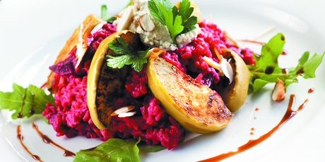 Beetroot risotto with baked apples, rocket and balsamic glaze. Photo / Supplied