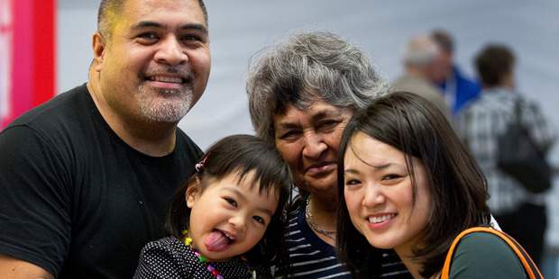 The arrival home of Rona Sapolu, left, his wife Noriko and daughter Sahana was a happy one for his mother Toeupu. Photo / Sarah Ivey
