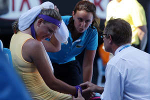 Victoria Azarenka being treated courtside at Melbourne on Thursday. Photo / AP