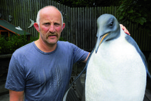 Gareth Morgan takes a shine to a penguin sculpture but thinks cats are serial killers. Photo / APN 