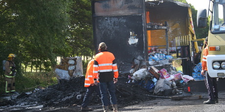 Firefighters battled the blaze that saw aerosols cans explode into the air shortly before their arrival. Photo / Manawatu Guardian