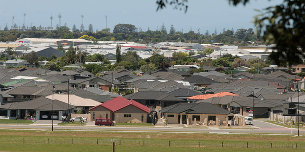 John Key has warned local councils - particularly Auckland - that they must start opening up land for housing development, or central government will step in. Photo / File