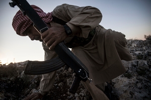 Syria's use of chemical weapons against rebels in a Damascus suburb sparked global outrage. An opposition fighter takes cover in Telata, Idlib province. Photo/ AP