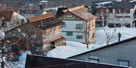 The sun rises over guest houses in Myoko Kogen's Akakura Kanko skifield, Japan. Photo / Kieran Nash